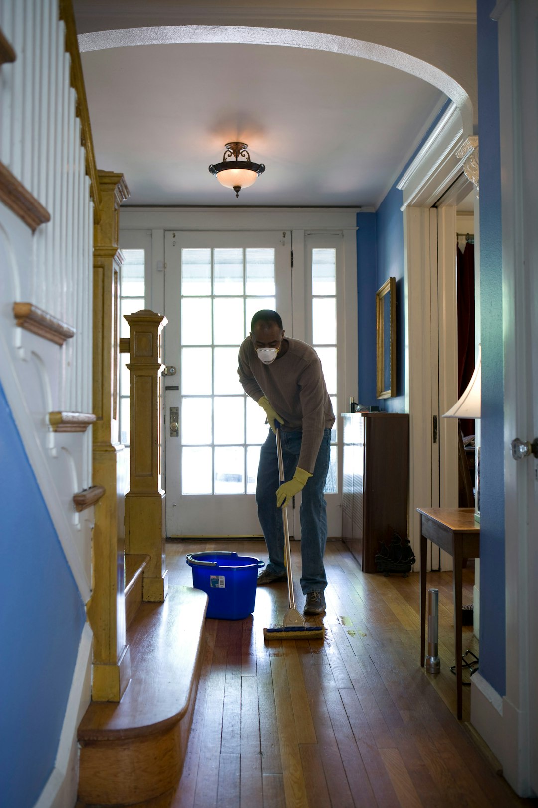 gallery-3 This African-American man was in the process of damp-mopping his home’s entrance way. In this way airborne particulates including dust and pollen, could be removed from the inside of his home, thereby, reducing the detrimental effects these substances have upon the respiratory system of his family members. These irritants can sometimes result in sinus infections, and asthma.
